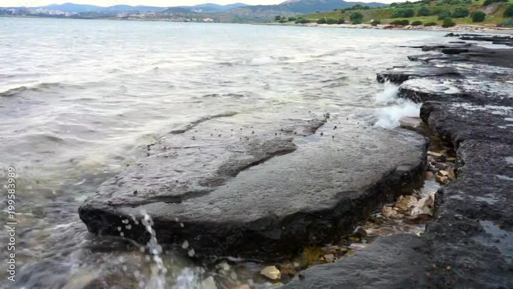 Calm Sea waves hitting rocks 