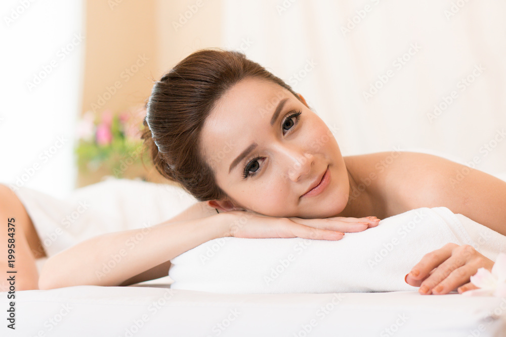 Beautiful woman lying down on the bed relax in spa salon with massage. Beautiful woman lying down on the bed relax in spa salon with massage.
