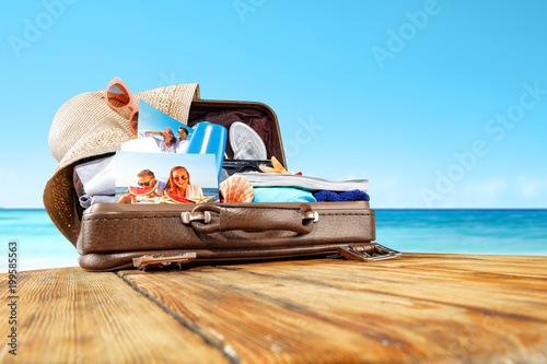 summer suitcase and beach background 