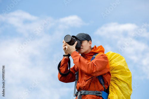 Picture of male photographer with camera and backpack