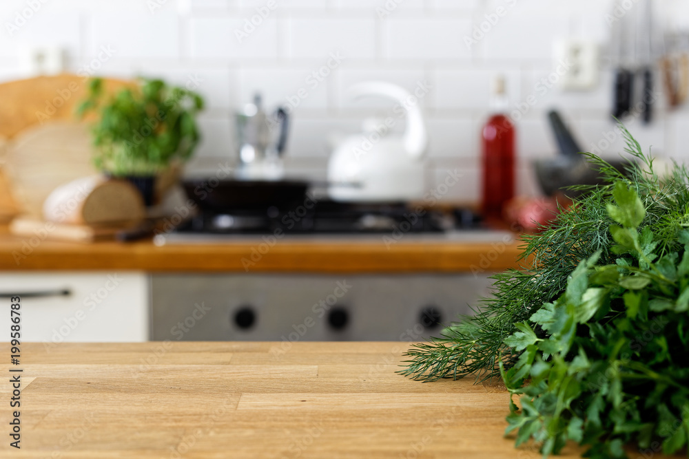 Fresh parsley and dill on wood counter with space for text. Out of focus home kitchen background. - obrazy, fototapety, plakaty 