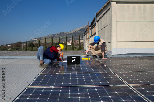 Wallpaper Mural young engineer girl and an elderly skilled worker fitting a photovoltaic plant Torontodigital.ca