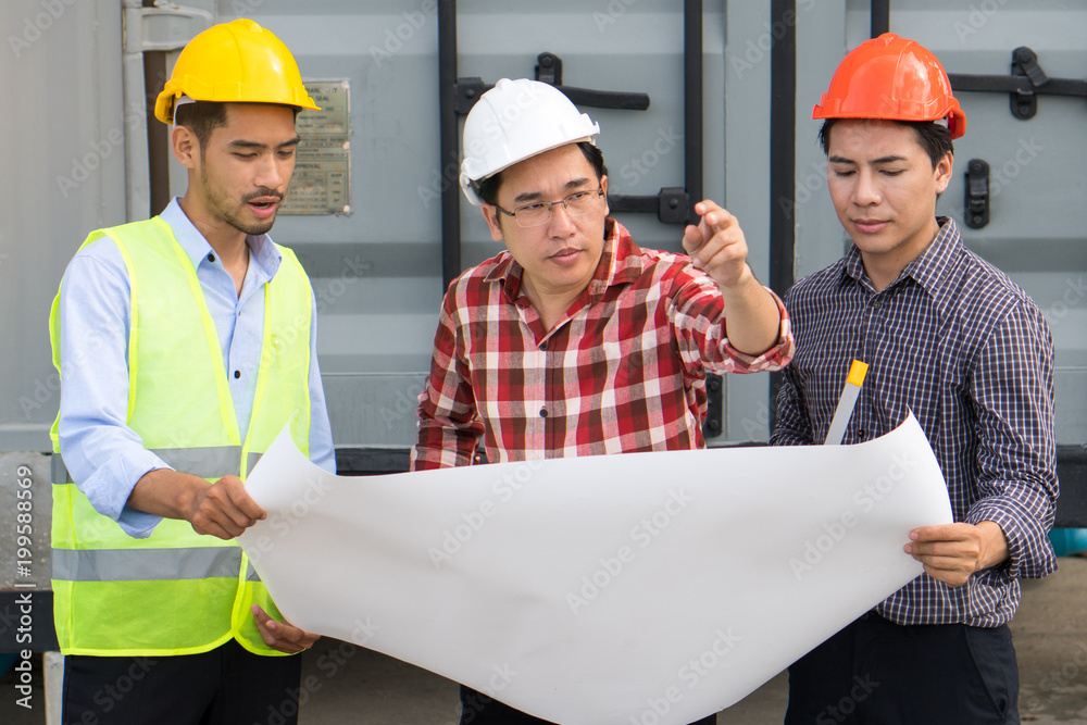 Concept Teamwork of building construction staff. Project engineer / contractor reviewing plan of work with foreman and worker at construction site. Concept Teamwork of building construction staff. Project engineer / contractor reviewing plan of work with foreman and worker at construction site.