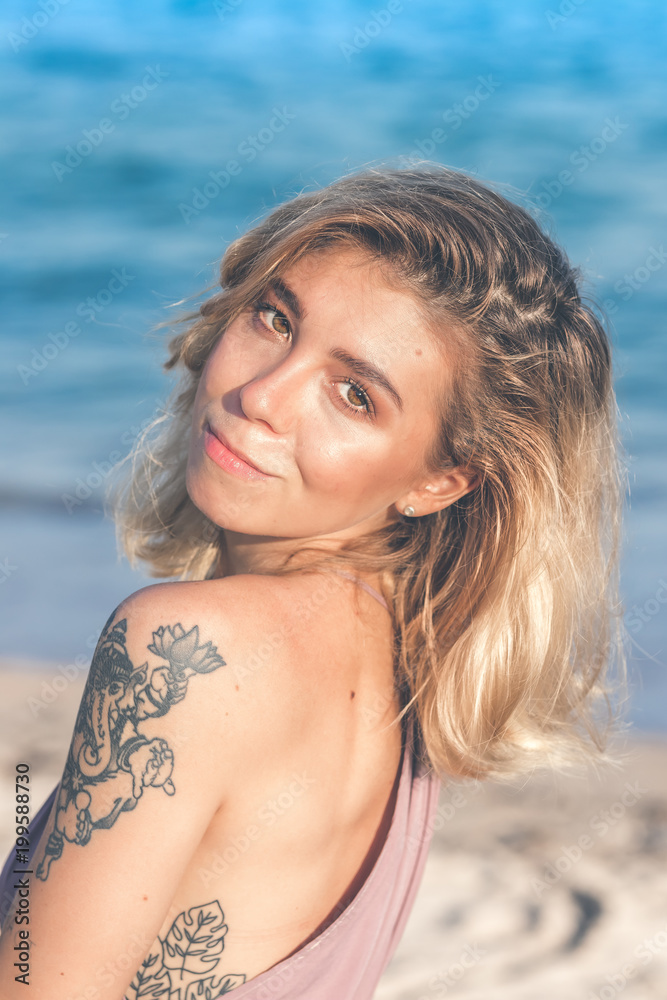 Sexy young woman posing on the tropical beach of Bali island, Indonesia. Asia.