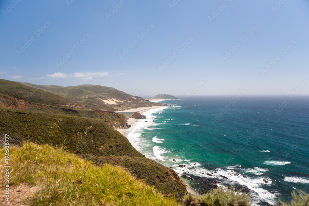 Rolling Hills and Waves Crashing on a Sandy California Beach