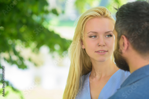 First meet of strangers, girl looks at bearded man