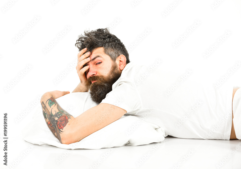 Man with sleepy face lies on pillow. Man with sleepy face lies on pillow.
