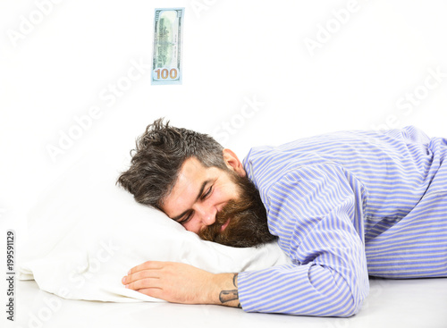 Dreaming of profit concept. Man with sleepy smiling face