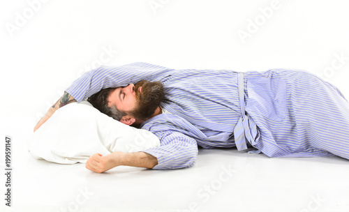 Man with sleepy face lies on pillow, sleeps.
