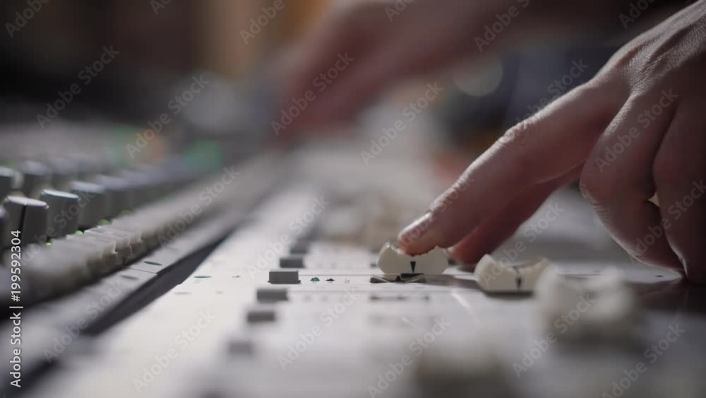 close up shot of the professional musician hands, people create music on the mixer with the help of the movement of the sliders responsible for the melody close up shot of the professional musician hands, people create music on the mixer with the help of the movement of the sliders responsible for the melody