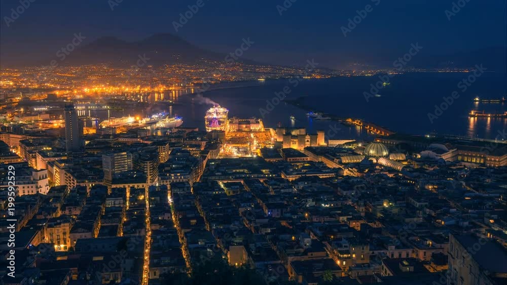 Naples, Italy. Time lapse of night aerial cityscape with skyline. View to the Vesuvius and seaport. Zoom effect Naples, Italy. Time lapse of night aerial cityscape with skyline. View to the Vesuvius and seaport. Zoom effect