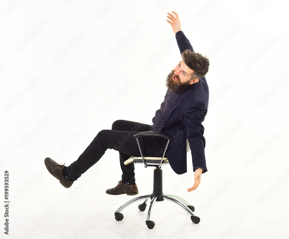 Overjoyed businessman riding in an office chair Overjoyed businessman riding in an office chair