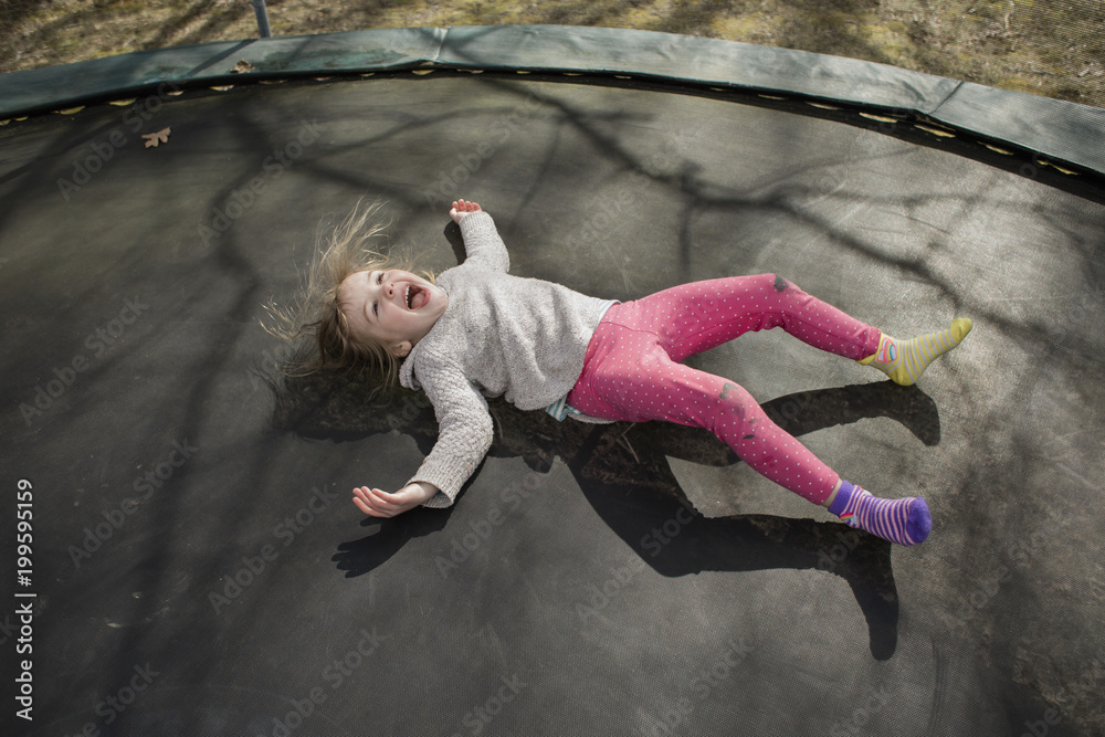 Young girl jumping on trampoline