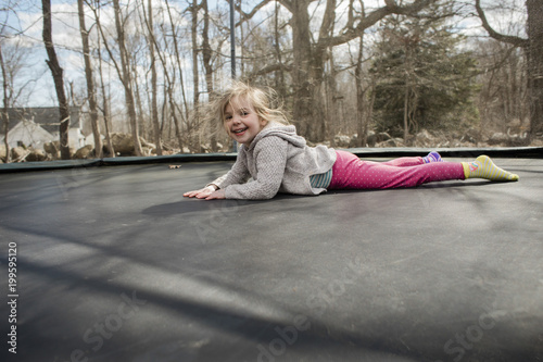 Young girl jumping on trampoline