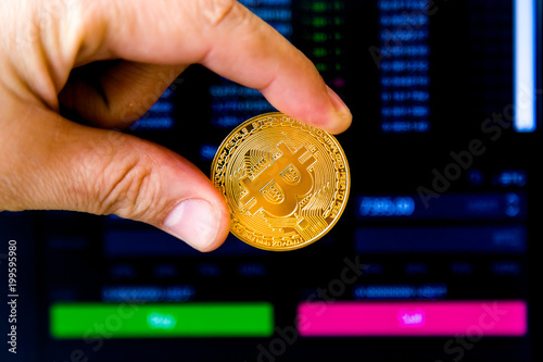 cryptocurrency in the hand against the background of the price chart