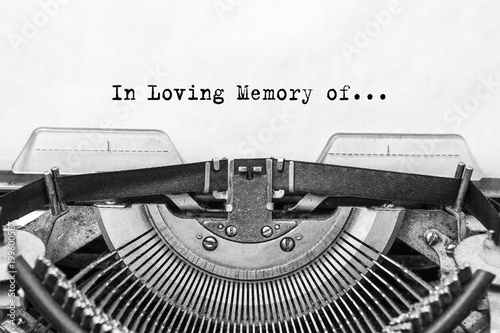 In the Loving Memory of, the text typed on is an old Typewriter. A vintage thing. close-up