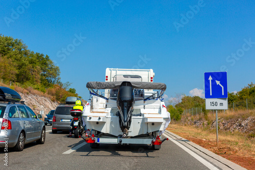 Motorhome with motor boat on the automotive trailer on the road in Istria, Croatia