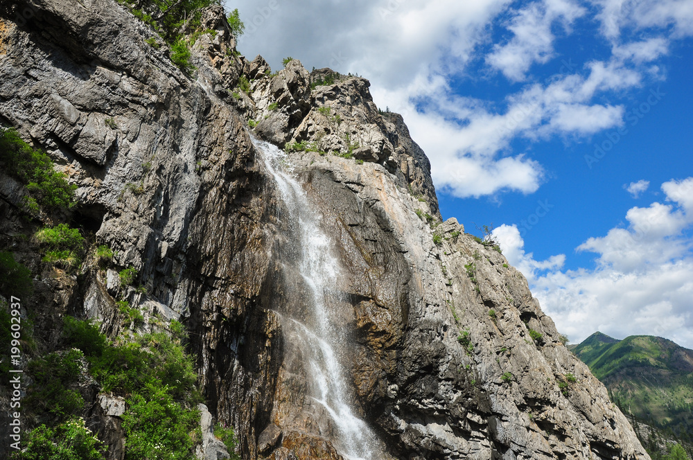 Waterfall on the rock. Named - Shirlak - Girl's tears . Altai, Siberia, Russia. Waterfall on the rock. Named - Shirlak - Girl's tears . Altai, Siberia, Russia.