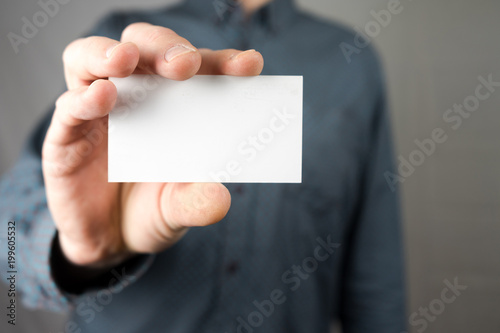 Businessman holding a business card. Mock up. Copy space.