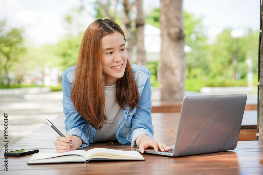 university student using internet search data for doing homework from computer in campus. university student using internet search data for doing homework from computer in campus.