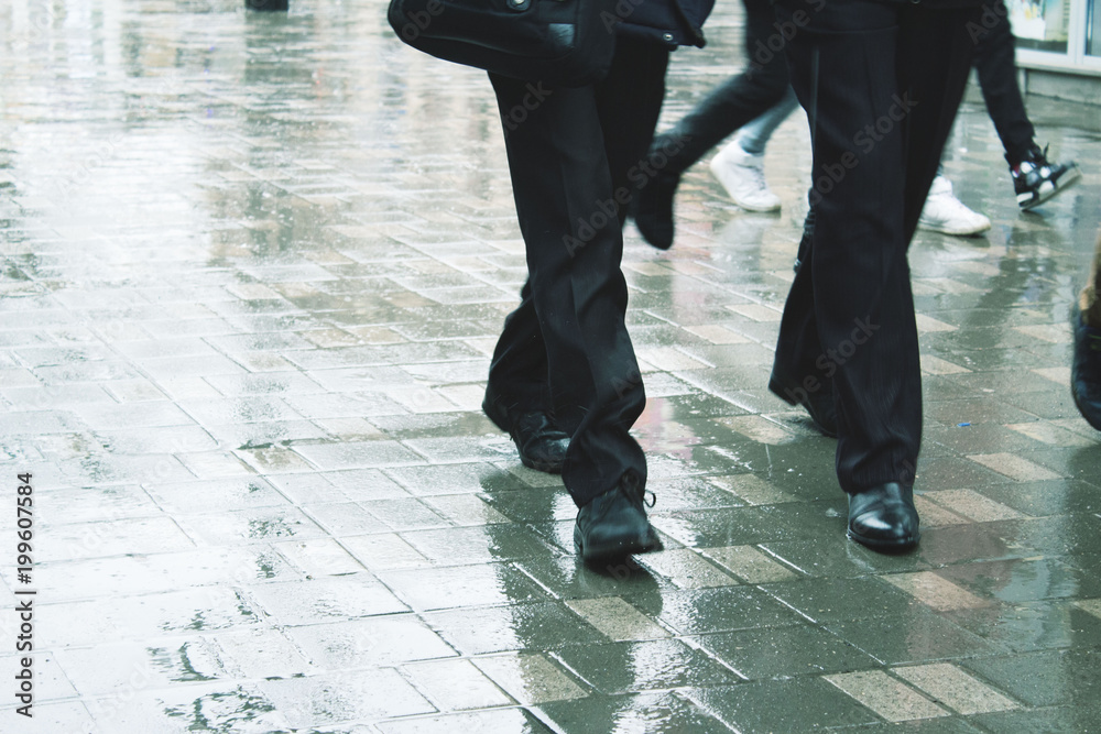 Obraz premium Person walking on the street in rainy day