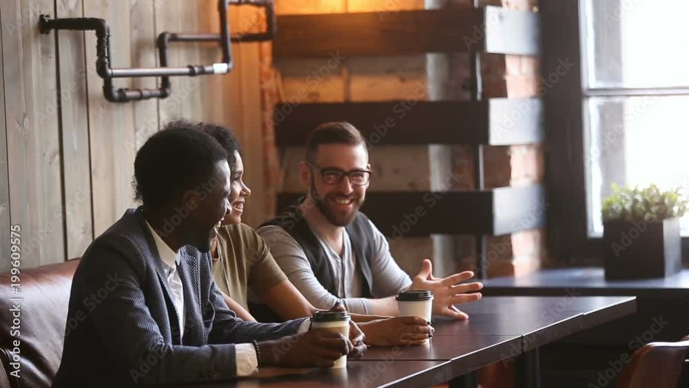 Young multiracial people get acquainted with happy caucasian couple greeting introducing shaking hands in cafe, new acquaintance and making friends concept, good first impression, nice to meet you
