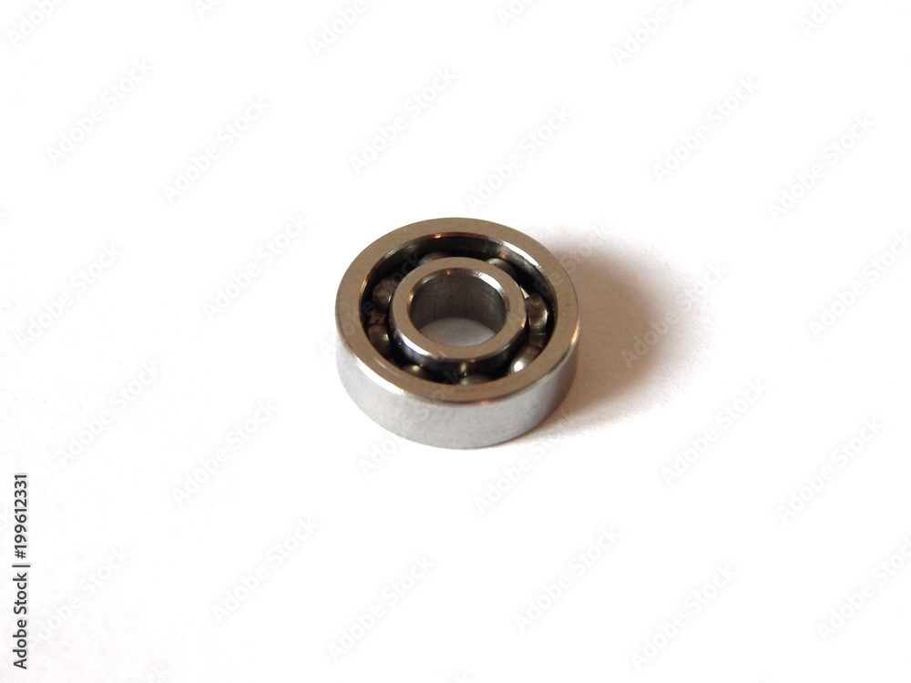 Ball bearing close-up. Photo of a ball-bearing on a white background. Metal ball-bearing friction. Ball bearing close-up. Photo of a ball-bearing on a white background. Metal ball-bearing friction.