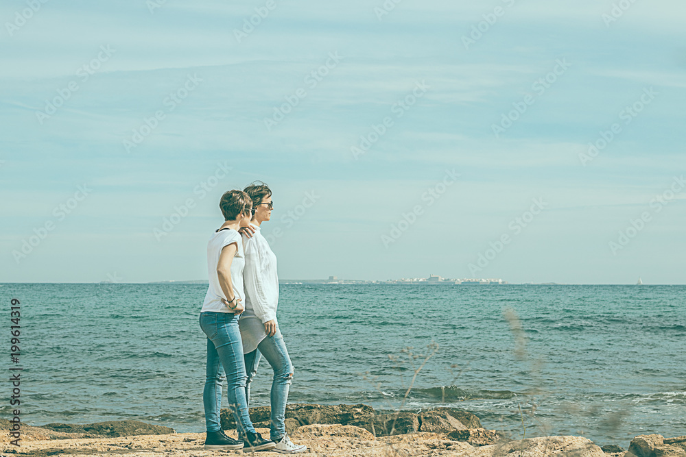 Two women looking out to sea. Two women looking out to sea.