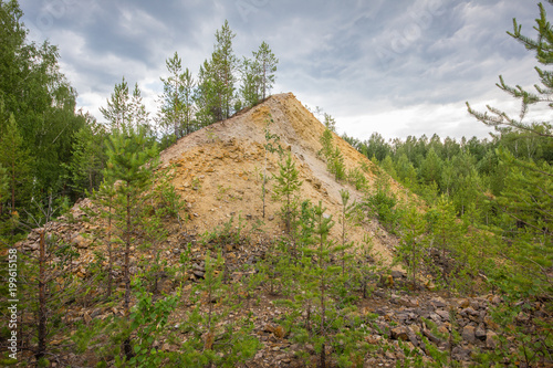 Underground old ore gold mine terricon slagheap rocks heap photo