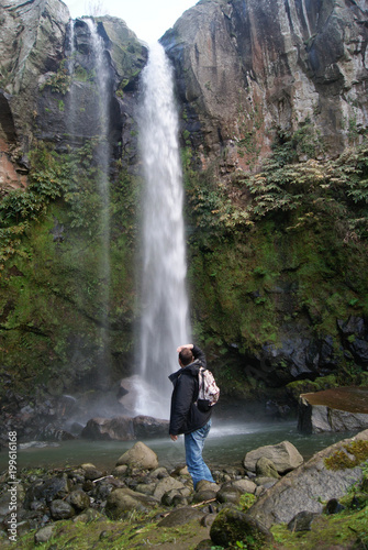 Hiker watching the waterfall of Salto do Farinha, Azores islands © JosManuel