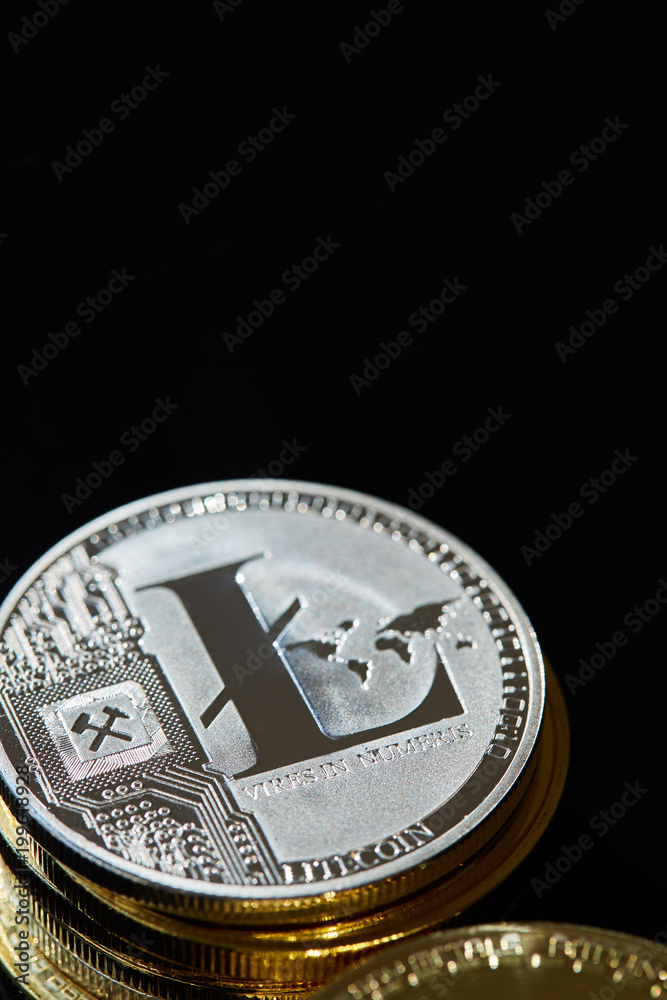 Silver coin of digital crypto currency with the symbol of Litecoin on a wooden background, close-up, macro Silver coin of digital crypto currency with the symbol of Litecoin on a wooden background, close-up, macro
