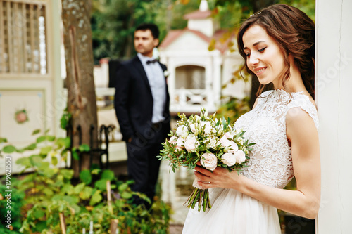 Bridal couple posing outdoor on their wedding day