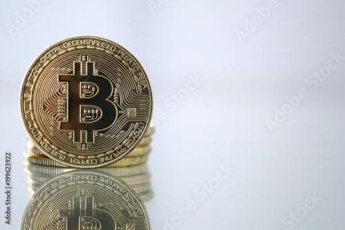 Golden Bitcoin facing the camera in sharp focus, close-up