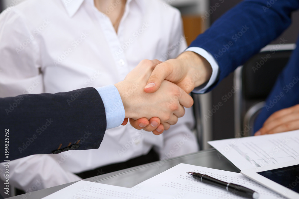 Business people shaking hands, finishing up a meeting. Audit, tax service or agreement concept Business people shaking hands, finishing up a meeting. Audit, tax service or agreement concept