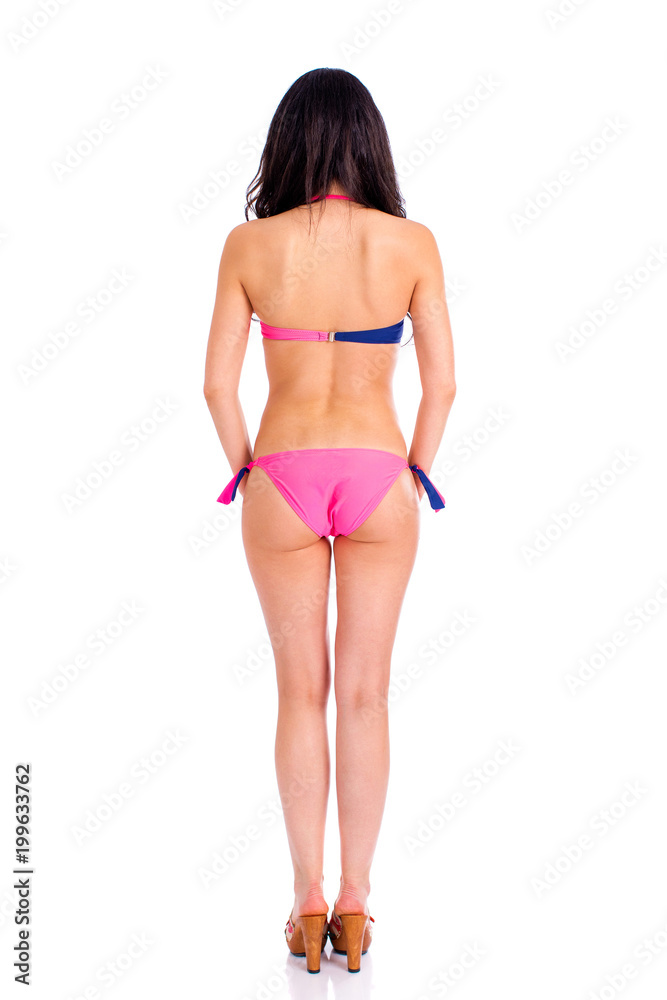 Back view. Snap model. Full length portrait of young woman wearing pink and blue bikini Back view. Snap model. Full length portrait of young woman wearing pink and blue bikini