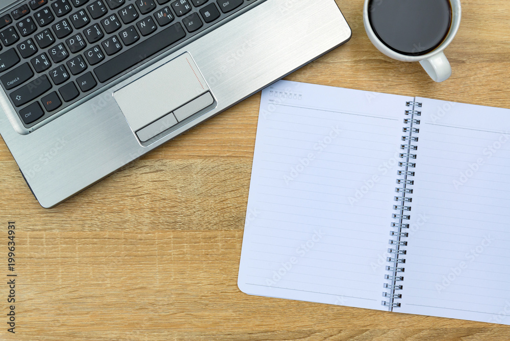 Laptop computer or notebook, note and cup of coffee on working table with copy space top view. Laptop computer or notebook, note and cup of coffee on working table with copy space top view.