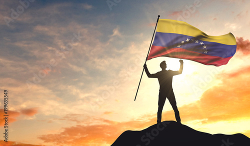 Venezuela flag being waved by a man celebrating success at the top of a mountain. 3D Rendering