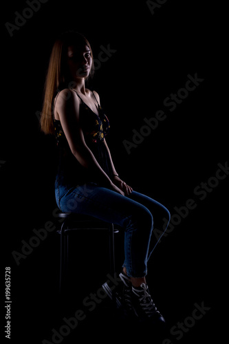 beautiful brunette girl sitting on a bar chair