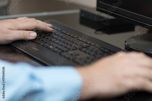 Hands typing on keyboard