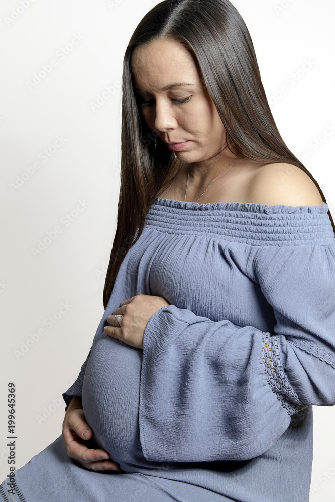 Pregnant Woman with Hands on Tummy and Smiling Pregnant Woman with Hands on Tummy and Smiling