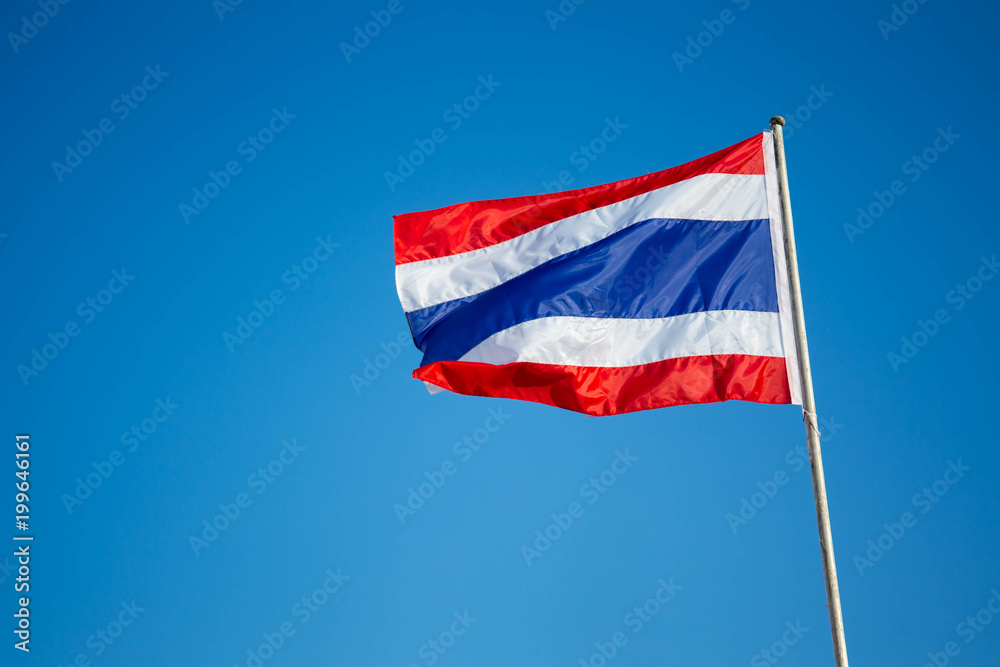Photograph of national Thai flag in the blue sky background. Photograph of national Thai flag in the blue sky background.