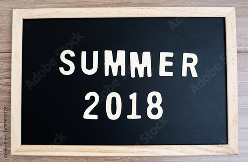 summer word wood text and 2018 happy new year on Blackboard and black background