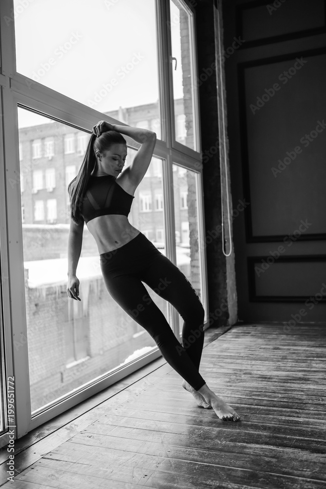 sports girl by the windows doing stretching sports girl by the windows doing stretching