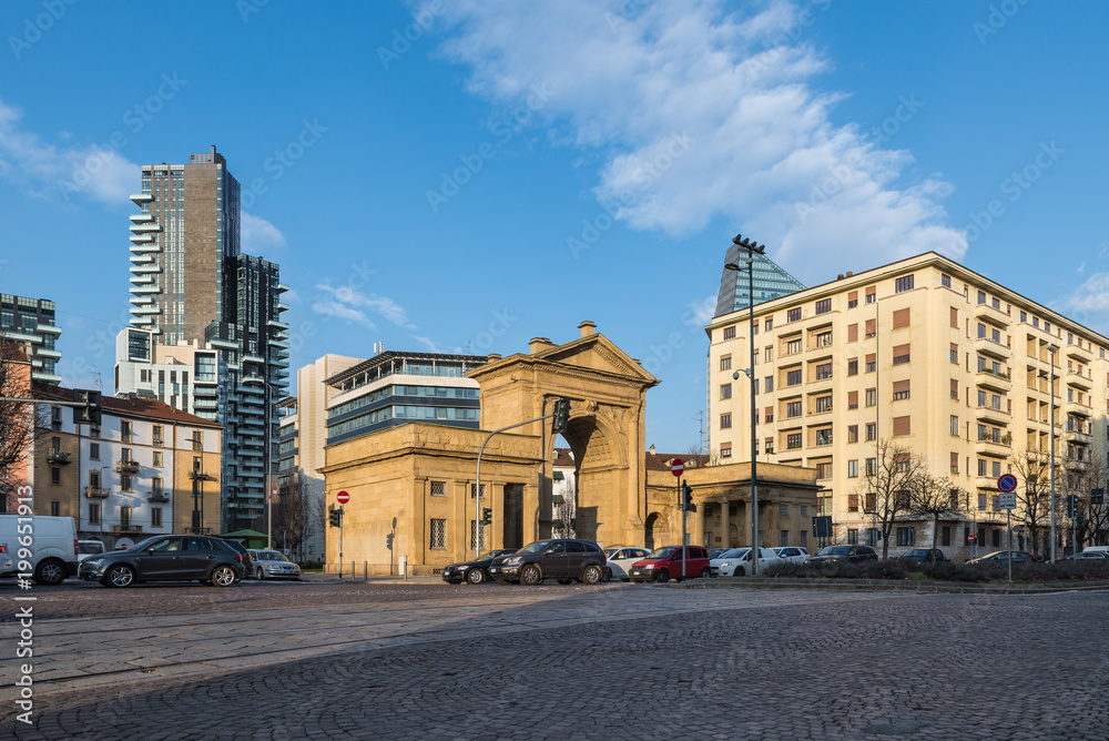 Milan Italy. Street scene at Porta Nuova, one of the six main gates of Milan. Piazzale Principessa Clotilde (square Princess Clotilde). Contrast between modern and ancient