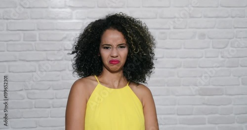 Facial Expressions Of Young Black Woman On Brick Wall