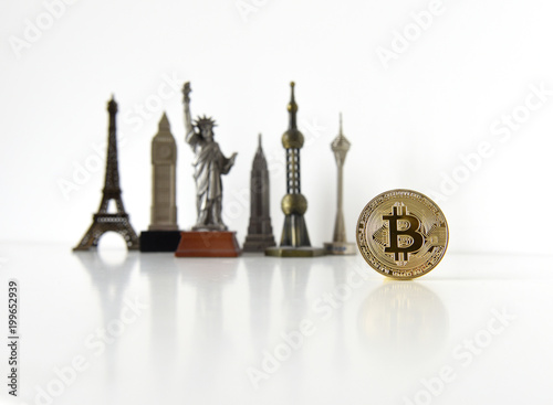 Bitcoin concept, cryptocurrencies. World economy concept. Golden coin bitcoin and souvenir from around the world. photo