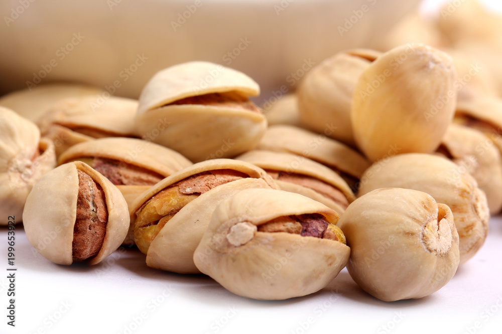 Unshelled roasted and salted cashew nuts isolated on white background