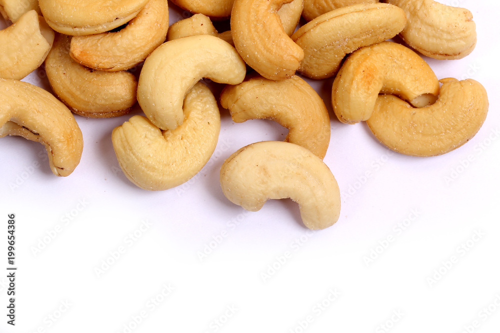 Unshelled roasted and salted cashew nuts isolated on white background Unshelled roasted and salted cashew nuts isolated on white background