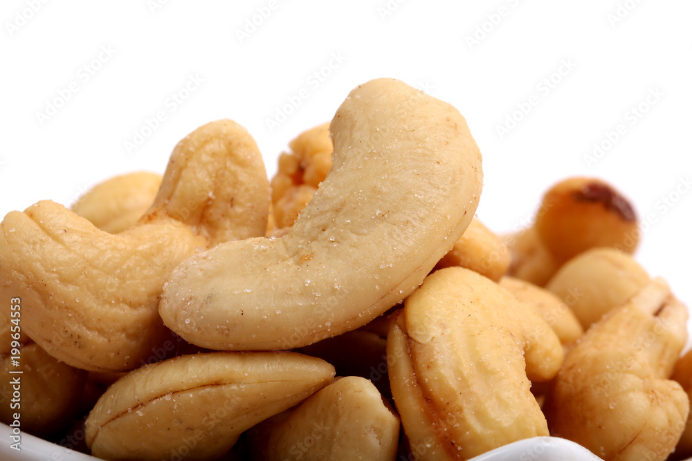 Unshelled roasted and salted cashew nuts isolated on white background Unshelled roasted and salted cashew nuts isolated on white background