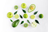 Green  fruits avacado, apples, lime and leaves creative concept top view on the white background.